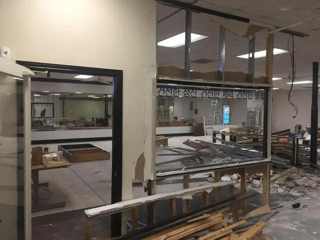 Commercial interior remodel in progress with new glass partitions and framing at Cho's Taekwondo