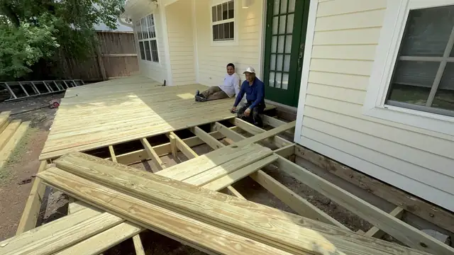 Two Integrity Roofing Pros crew members on a freshly decked pressure-treated wood deck